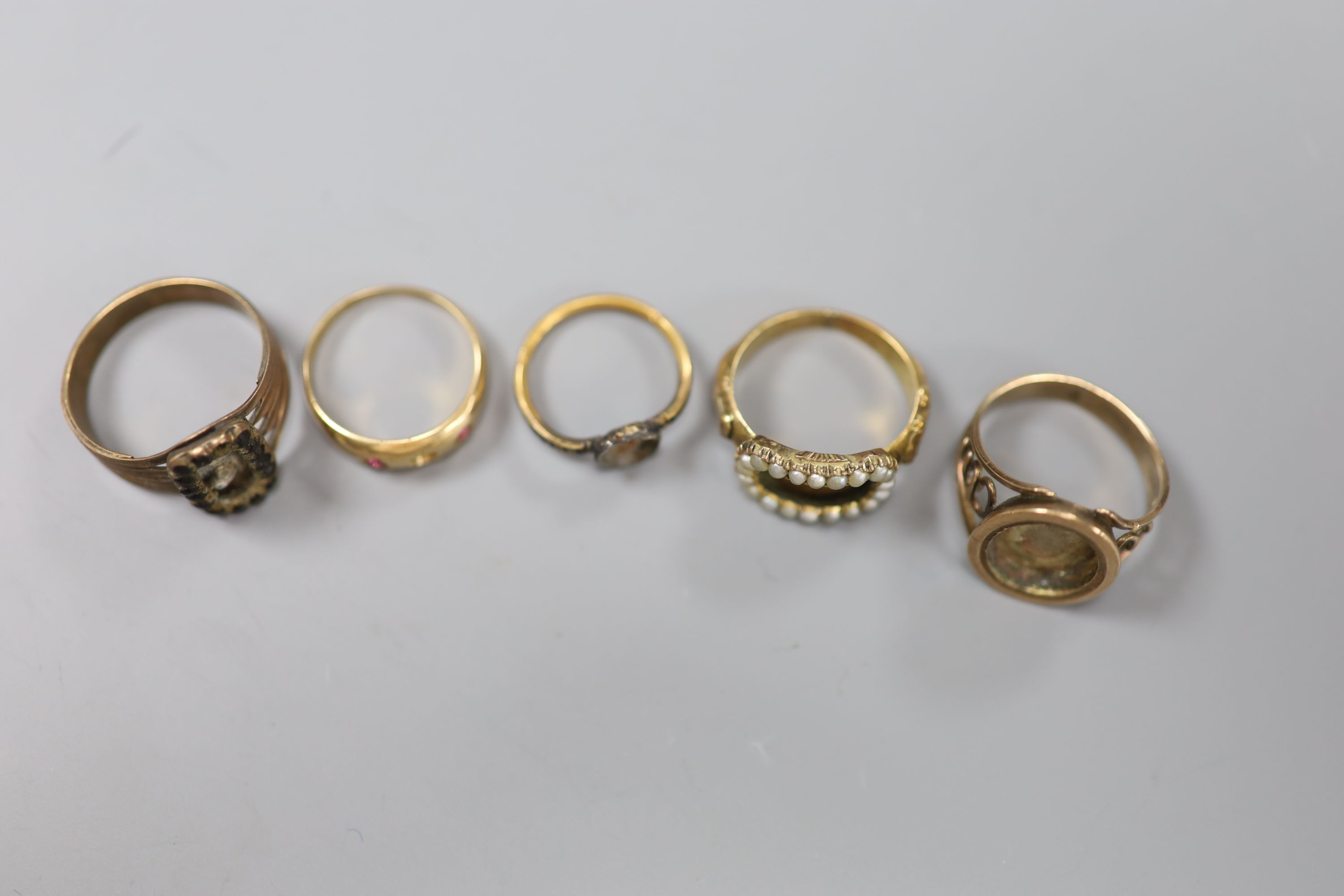 A 15ct and gem set ring 9a.f.) gross 2.3 grams and four other 19th century yellow metal rings(a.f.)